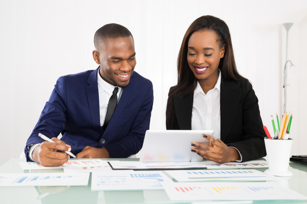 Growing business team reviewing performance on a tablet